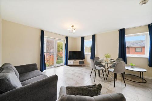 a living room with a couch and a table at Peaceful 2BR Flat with Historic Bottle Kilns View & Free Parking Located near City Centre in Stoke on Trent
