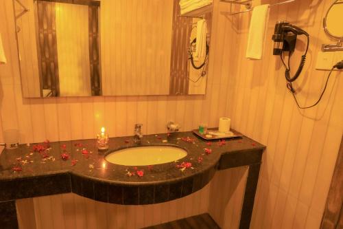 a bathroom with a sink with flowers on it at Bharatpur Garden Resort in Bharatpur