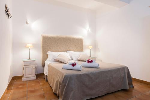 a bedroom with a bed with two pillows on it at Calliope's Apartments - Stella del Mare in Siracusa