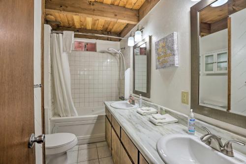a bathroom with two sinks and a toilet and a tub at Big Bear Retreat with Fenced Yard Near Ski Resorts! in Big Bear Lake