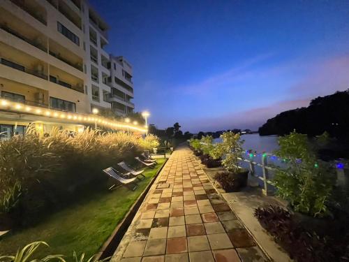 a walkway in front of a building at night at USABAI Riverside Boutique Hotel in Chanthaburi