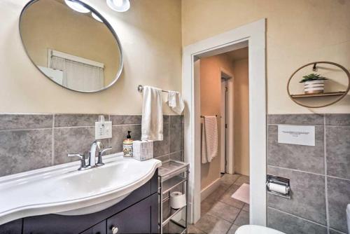 a bathroom with a sink and a mirror at Historic Apartment - Walk to CSU Campus and Old Town in Fort Collins
