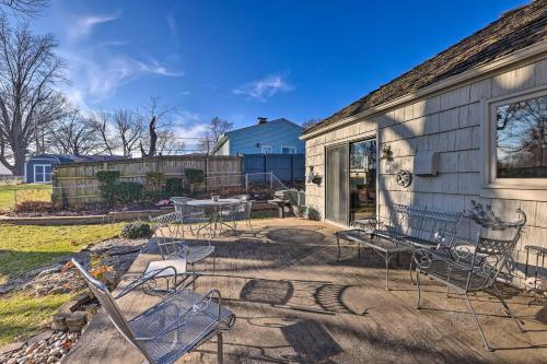 a patio with chairs and a table in front of a house at Cozy Kansas City Home with Yard - 9 Mi to Dtwn! in Kansas City