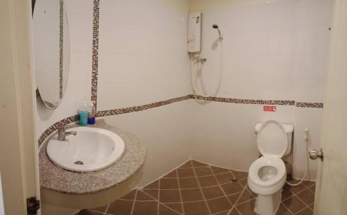 a bathroom with a sink and a toilet at Marina Seaview Krabi in Krabi town