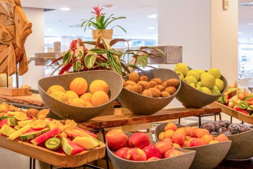 a bunch of bowls of fruit on a display at Sol Palmanova Mallorca in Palmanova