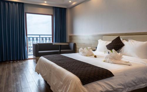 a bedroom with a large bed with a large window at G.C ROYAL HOTEL in Accra