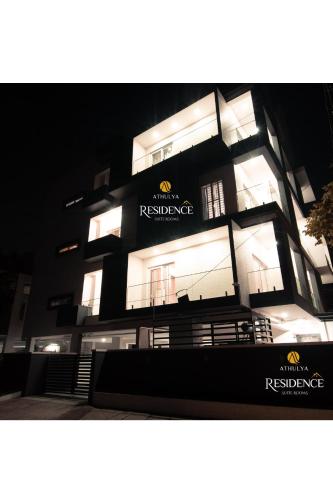 a building with lights on in front of it at Athulya Residence Suite Rooms in Bengaluru
