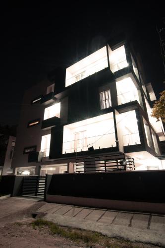 a large building with lights on at night at Athulya Residence Suite Rooms in Bengaluru