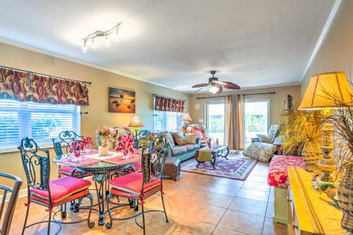 a living room with a table and chairs at Sleek Pensacola Beach Condo Patio, Walk to Beach in Pensacola Beach