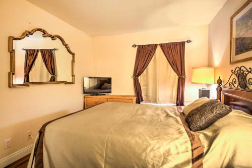a bedroom with a bed and a mirror and a television at Pet-Friendly Las Vegas Condo 1 Mi to the Strip! in Las Vegas
