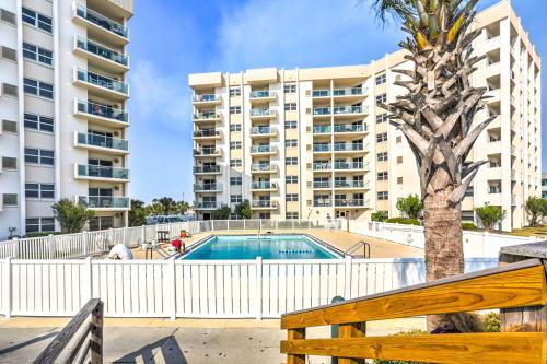 a pool in front of a large apartment building at Sleek Pensacola Beach Condo Patio, Walk to Beach in Pensacola Beach