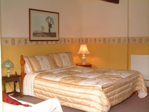 a bedroom with a large bed in a room at RolandsCroft Guest House in Pontefract
