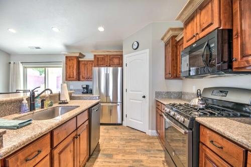 a kitchen with wooden cabinets and a stainless steel refrigerator at Scenic La Verkin Home 20 Mi to Zion National Park in La Verkin