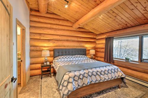 a bedroom with a bed in a log cabin at Fairbanks Log Cabin with Waterfront Deck and Views! in Fairbanks