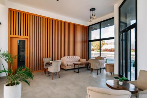 a living room with a couch and chairs at Cezar's Airport Hotel in North Nicosia