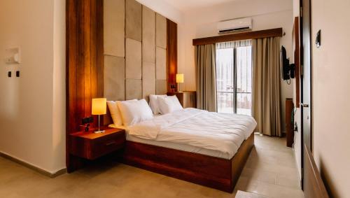 a bedroom with a bed and a large window at Cezar's Airport Hotel in North Nicosia