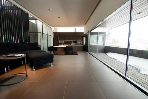 a living room with a couch and a table at Sapporo boukyo Luxury house 5 pax Free Parking in Sapporo