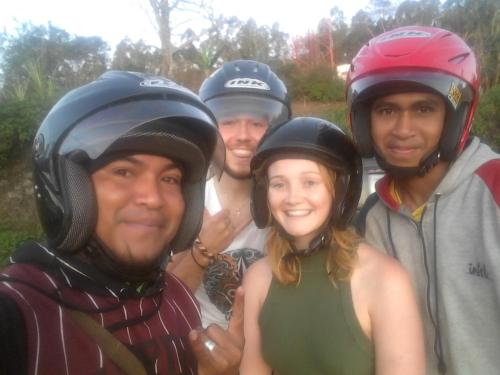 a group of people wearing helmets posing for a picture at Kristian Homestay in Bajawa