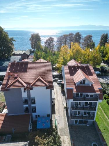 an aerial view of two buildings with the ocean in the background at Villa Natali in Ohrid