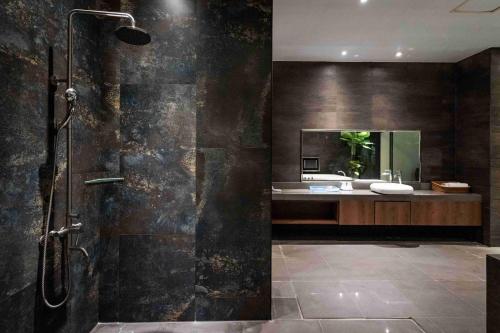 a bathroom with a shower and a sink at Aquarius Motel in Taichung