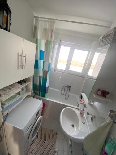 a small bathroom with a sink and a toilet at Danube in Vukovar