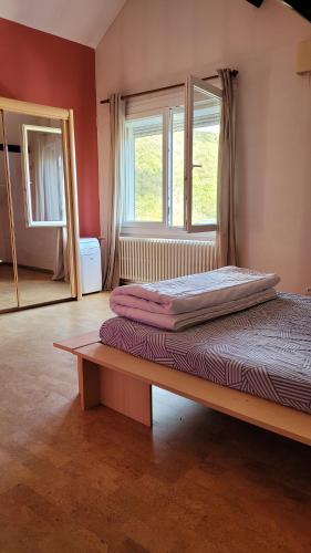 a bed sitting in a room with a window at Maison familiale à Haybes in Haybes