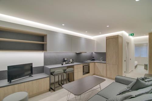 a kitchen and living room with a couch and a table at ''Γειτονιά της γνώσης'' Luxury Apartments Ioannina in Ioannina