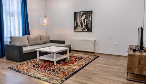 a living room with a couch and a coffee table at Zakarias Apartments in Miercurea-Ciuc