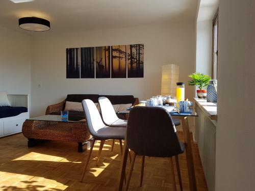a living room with a table and chairs at Ferienwohnung Schloßberg 1 in Peiting