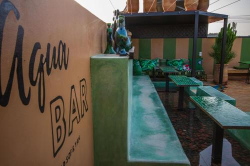 a restaurant with green benches in a room at Riad SofYan & Spa in Marrakesh