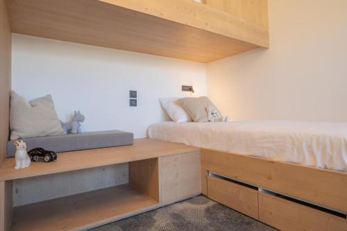 a bedroom with two beds and wooden shelves at La Cachette, Friendly Hotel & Spa in Arc 1600