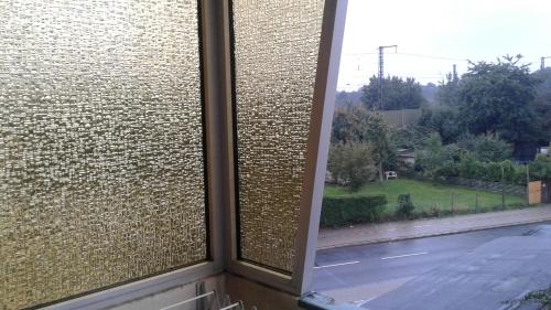 a window with a brick wall with a view of a street at Ferienwohnung Julechka in Bremerhaven