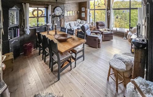 a living room with a wooden table and chairs at Stunning Home In seral With House A Mountain View in Åseral