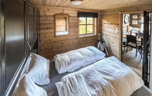 a bedroom with two beds in a wooden cabin at Stunning Home In seral With House A Mountain View in Åseral