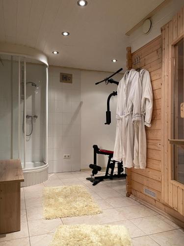 a bathroom with a walk in shower and a treadmill at Ferienwohnung Conny in Gröbming