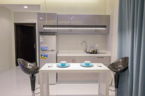 a kitchen with a white table and two chairs at شقق واي سويت للشقق المخدومة in Abha
