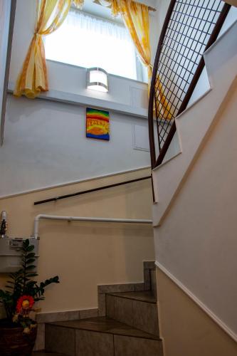 a staircase in a house with a window at Luca Apartman in Esztergom