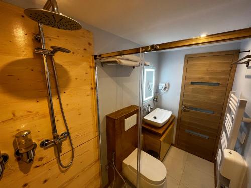 a bathroom with a shower and a toilet and a sink at 9WAGRAM Hotel Boutique in Le Mans