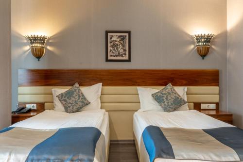a hotel room with two beds and two lights at Residence Hotel By Ketenci in Izmir