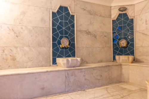 a bathroom with two sinks and two stained glass windows at Residence Hotel By Ketenci in Izmir