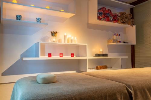 a room with two beds and shelves with candles at Residence Hotel By Ketenci in Izmir