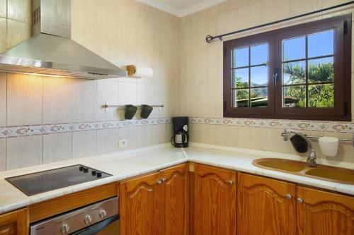 a kitchen with a sink and a window at Casa Mariposa in Valsequillo