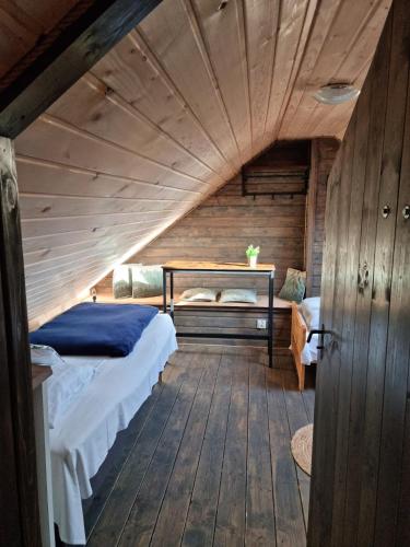 a bedroom with a bed in a wooden ceiling at Ostoja Karkonoska in Podgórzyn