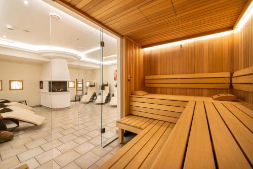 a sauna with a bench in a room at Hotel & Restaurant Wastlwirt in Sankt Michael im Lungau