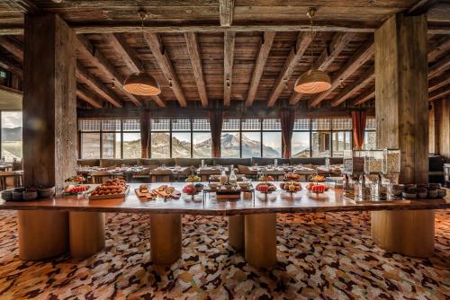 a large dining room with a large table with food on it at Le Refuge de Solaise - 2551 m Altitude in Val dʼIsère