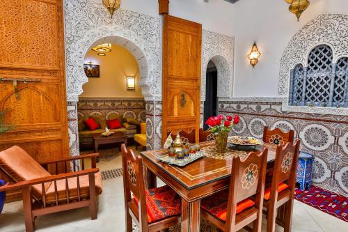 uma sala de jantar com mesa e cadeiras em Riad Alech em Essaouira