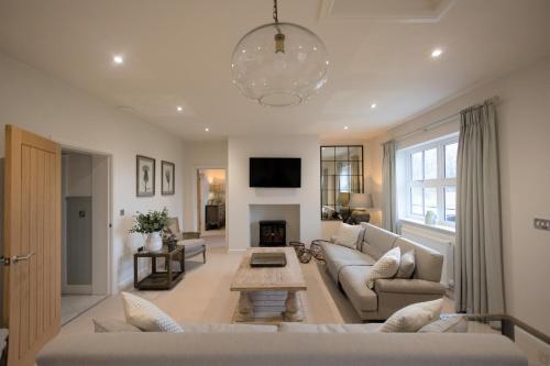 a living room with a couch and a table at Woodlands Cottage, Wynyard Hall in Grindon