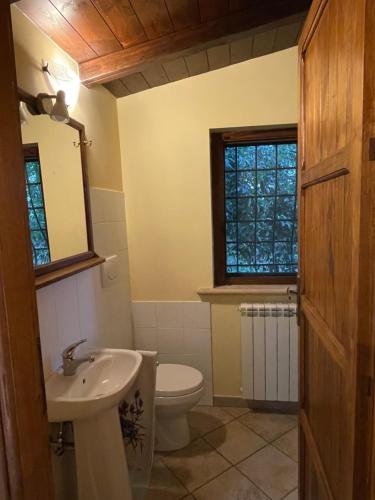a bathroom with a white toilet and a sink at B & B Casal Pereto in Valmontone