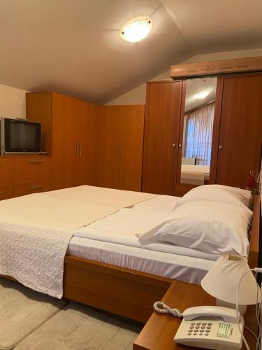a bedroom with a bed with a phone and a phone at Luxory aparthotel in 4 star SPA hotel st Ivan Rilski, Bansko in Bansko
