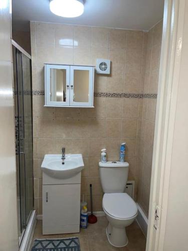 a small bathroom with a toilet and a sink at room with share bathroom Near train line in London